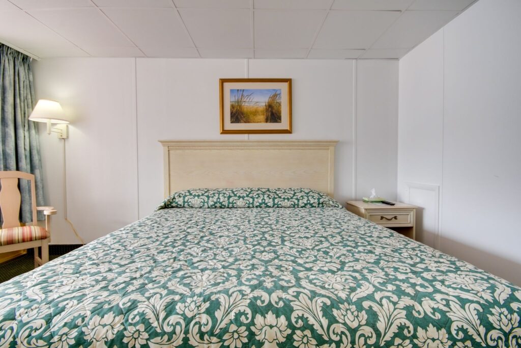 a bed with a green and white bedspread